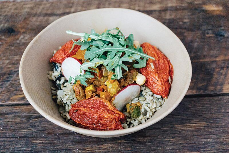 At plant-based fast casual Shouk, in Washington, D.C., the Ratatouille Rice & Lentil Bowl is topped with roasted tomato “bursts,” radish, chickpeas, arugula and creamy sesame-seed sauce.
