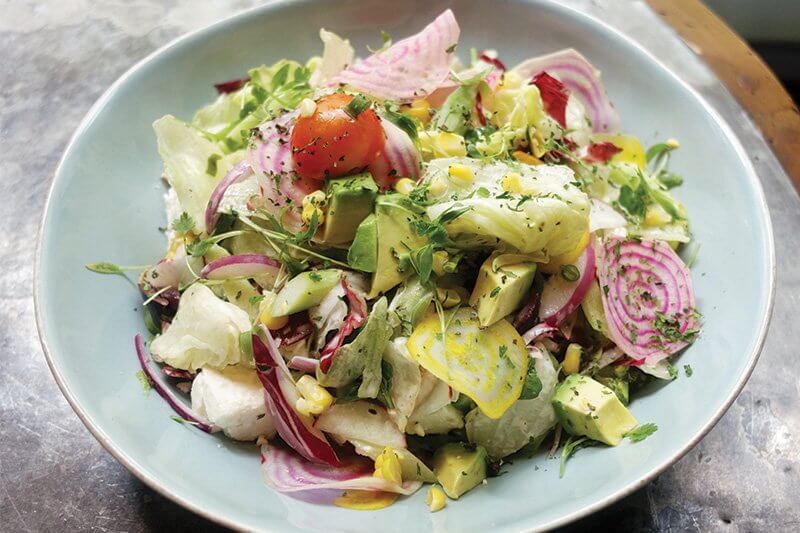 An intentional approach marks today’s salad. At The Vine in New York, Laurent Tourondel creates a masterfully balanced Vegetable Chopped Salad with modern ingredients like baby beets and radishes.
