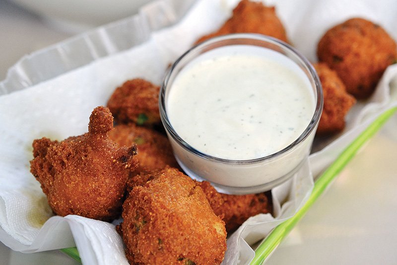 Crispy hushpuppies studded with jalapeño get a refreshing cool-down with a creamy icebox buttermilk ranch dip.