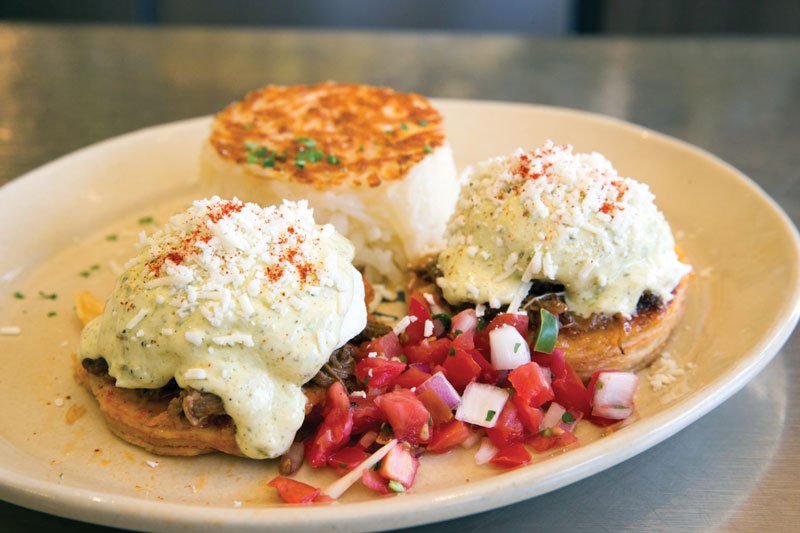 Both bold and comforting, Chilaquiles Benedict at Denver-based Snooze incorporates barbacoa, tortillas draped in ranchero sauce, poached eggs, poblano hollandaise and pico de gallo.
