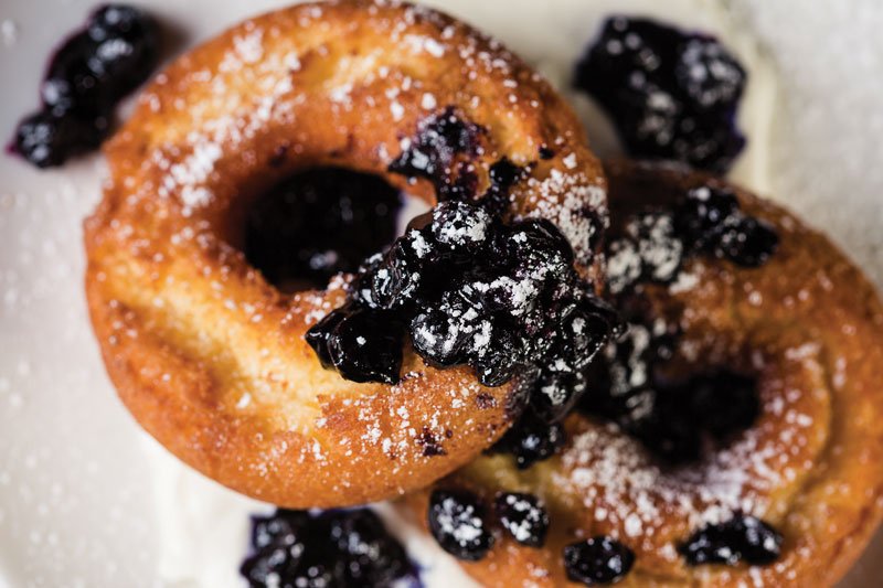 Sour cream cake doughnuts are finished with blueberry compote and whipped crème fraîche at Alamo Drafthouse Cinema