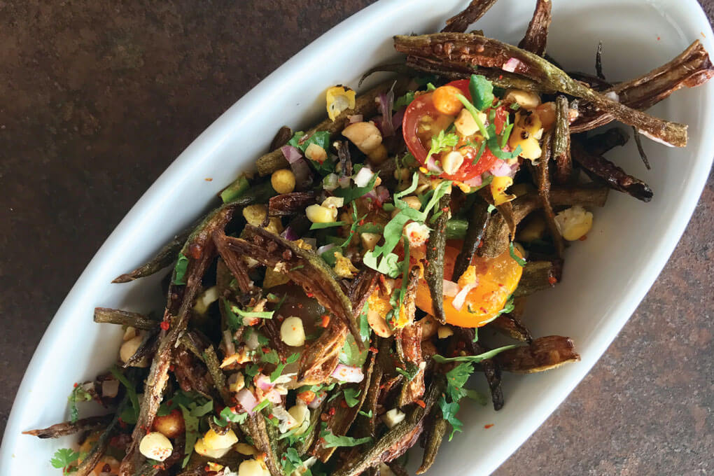 At Snackbar in Oxford, Miss., a fascinating combination of Southern, French and Indian flavors finds flavorful synergy in dishes like the Okra Chaat. It features crispy fried okra, tomatoes, onion, cilantro, peanuts, lime and chaat masala. 