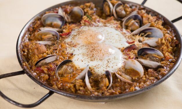 Paella With Chicken, Chorizo, Clams And Shirred Eggs