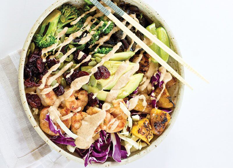 Avocado joins shrimp, pineapple, broccoli, tart cherries and much more in this festive Tropical Buddha Bowl, drizzled with almond-lime dressing.