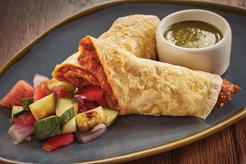 Bindaas in Washington, D.C., known for Indian street food and snacks, menus this Chicken Kathi Roll, stuffed with chicken tikka masala and fenugreek.