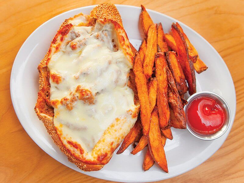 The Big Ragout Sandwich at Blue Collar in Miami loads up tender ragout meats inside a crusty hoagie roll. Melty Provolone tops it off.