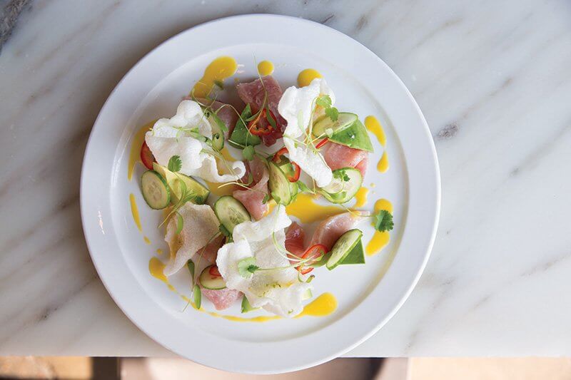 Bright, clean flavors with just a prickle of heat are part of the new raw fish trend. At Acorn in Denver, Colo., Hamachi Crudo stars passion fruit vinaigrette, avocado, Persian cucumber and Fresno chili. 