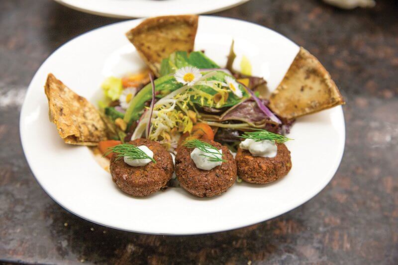Here, chickpea flour and ground roasted peanuts form falafel bites, proving their potential as a base for flavor innovation.