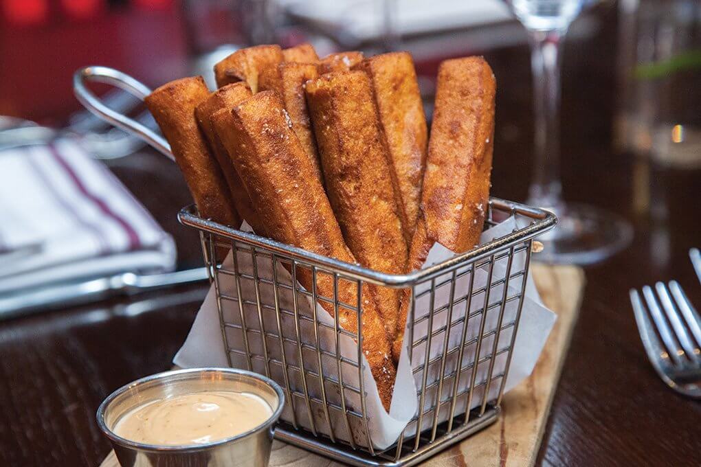 Irresistibly crispy, the chickpea fries at David Burke Fabrick in New York get a dusting of fennel pollen and are served with complementary dips, like harissa mayonnaise or chipotle aïoli.