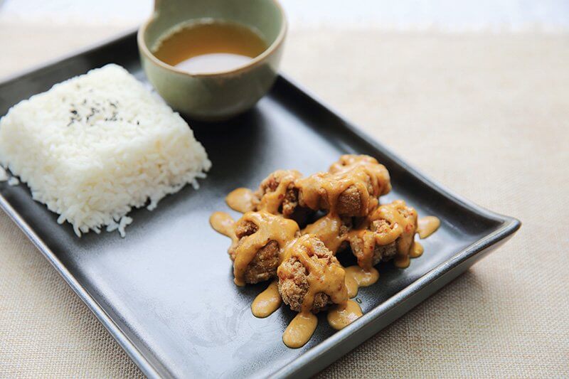 Crispy bites of karaage, Japanese fried chicken, get hit with a sweet-savory sauce for added craveability.