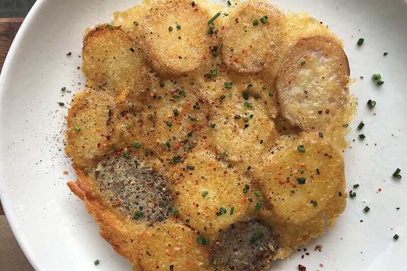 Sliced marble potatoes form the base in this Cacio e Pepe side dish at L’Amico in New York.