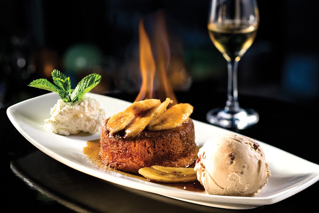 The Hot “Bananas Foster” Butter Cake at Eddie V’s merges comfort and indulgence. Butter is the theme here: butter cake, butter pecan ice cream and butterscotch.