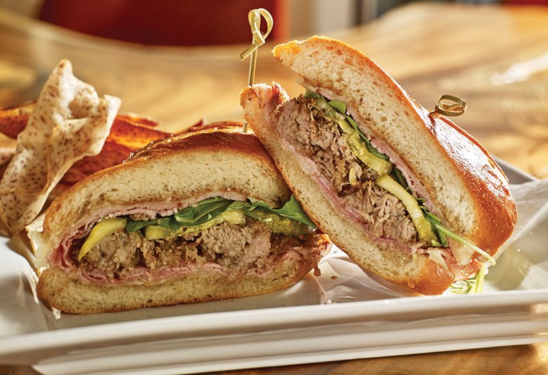 At Boston’s La Casa de Pedro, the Cubano gets a signature touch with the addition of housemade spicy pickles and cilantro dressing.