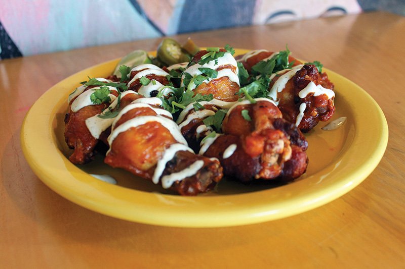 At En Su Boca in Richmond, Va., Salt Brined Chicken Wings Al Pastor star a housemade Buffalo sauce, pickled jalapeño and Fresno chiles, with a drizzle of lime crema.
