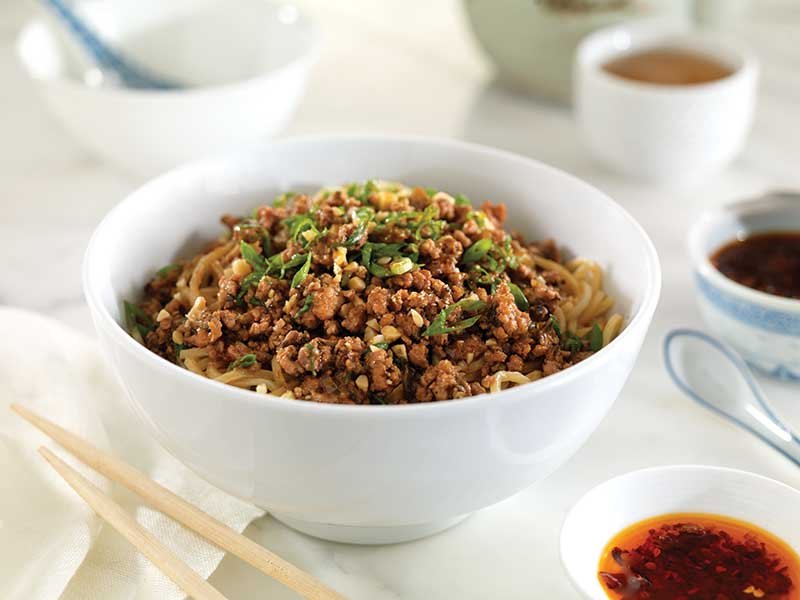 Ground pork is seasoned with chile oil, soy sauce, rice vinegar and sesame paste.