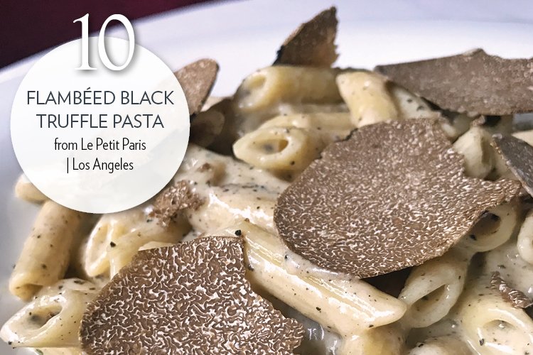 Flambéed Black Truffle Pasta - Black truffle pasta flambéed in Cognac in a Parmesan cheese wheel, topped with fresh truffles