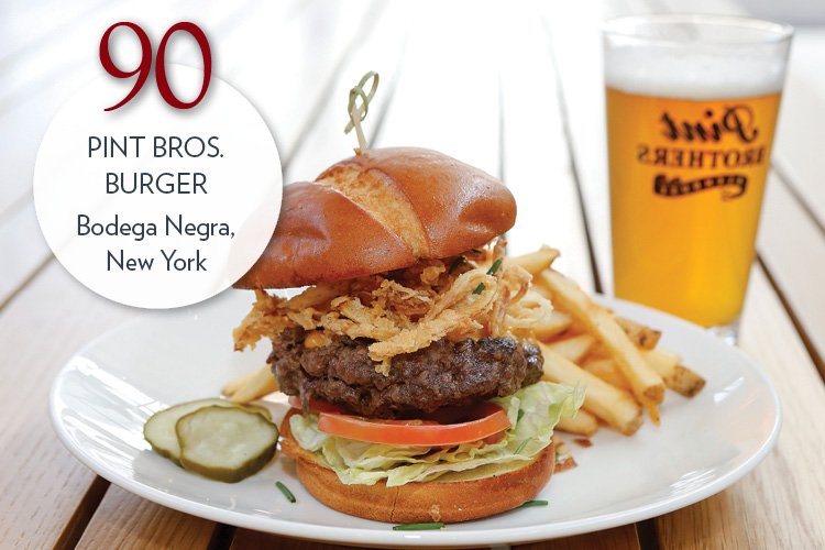 Pint Bros. Burger with beer cheese, tomato, chives, crispy onions, toasted pretzel bun