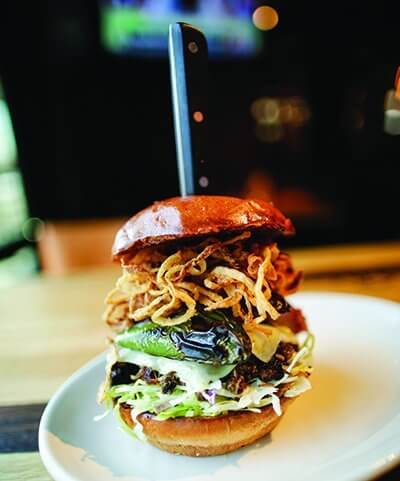 Dubbed “The Ultimate,” Wood Ranch’s new sandwich includes Carolina pulled pork, Carolina slaw, brisket, Swiss cheese, kielbasa, charred jalapeño and onion strings.