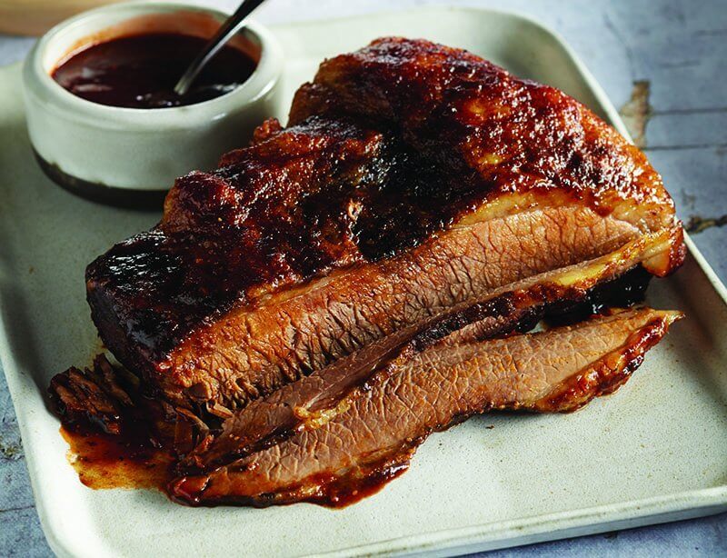 Texas barbecued beef brisket is anchored in authenticity and prepared with time-honored technique, but can still be updated with improvised sauces and spices.