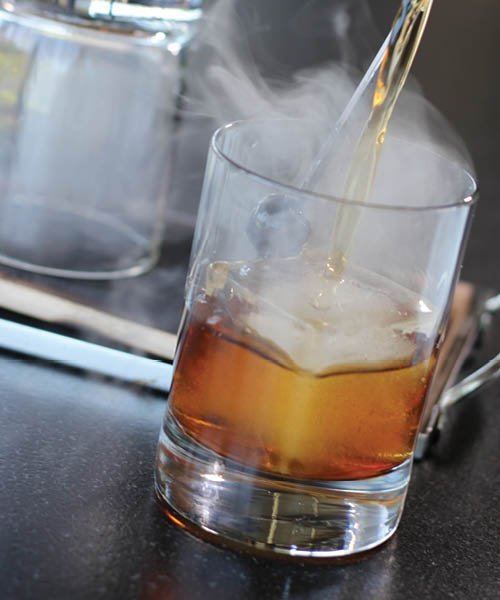 For Ivy Kitchen’s Bootstrap Manhattan, with TX Whiskey, sweet vermouth, bitters and Luxardo Cherry, a torch is used to create maple smoke that clings to the glass