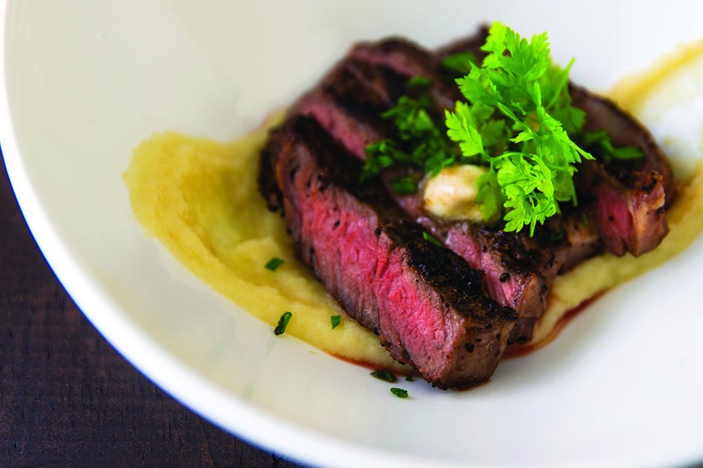 This grass-fed ribeye offers menu cues that convey values important to today’s diners. On-trend flavor descriptors further enhance: coffee-rubbed and served with bourbon butter atop parsnip purée.