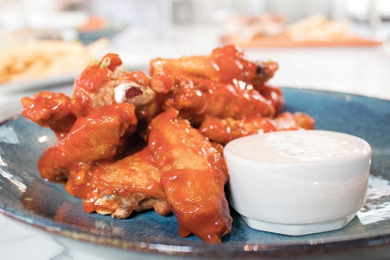 At Canvas Restaurant & Market in Orlando, Fla., the Habanero Glazed Chicken Wings showcase a modern profile with clover honey, lime zest and a garlic-buttermilk dipping sauce.