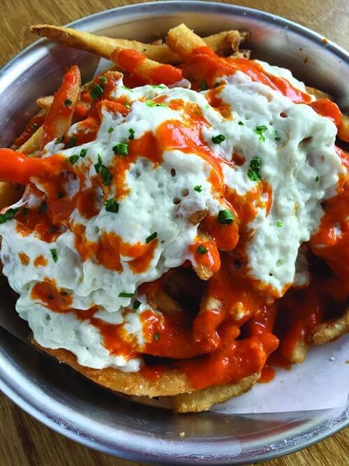 In the Buffalo Poutine at Red Herring in Louisville, Ky., bourbon barrel-aged hot sauce contrasts nicely with the tangy-sweet melted blue cheese.