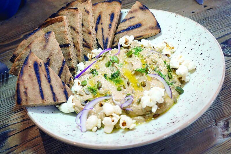 Popcorn and pepitas perk up the Roasted Cauliflower Hummus at Chicago’s The Little Beet Table