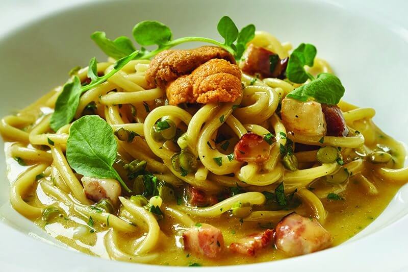 The Salt Line offers this decadent Uni Carbonara: bucatini, yolks, house bacon, garlic scapes, black pepper, Grana Padano—and a generous serving of uni.