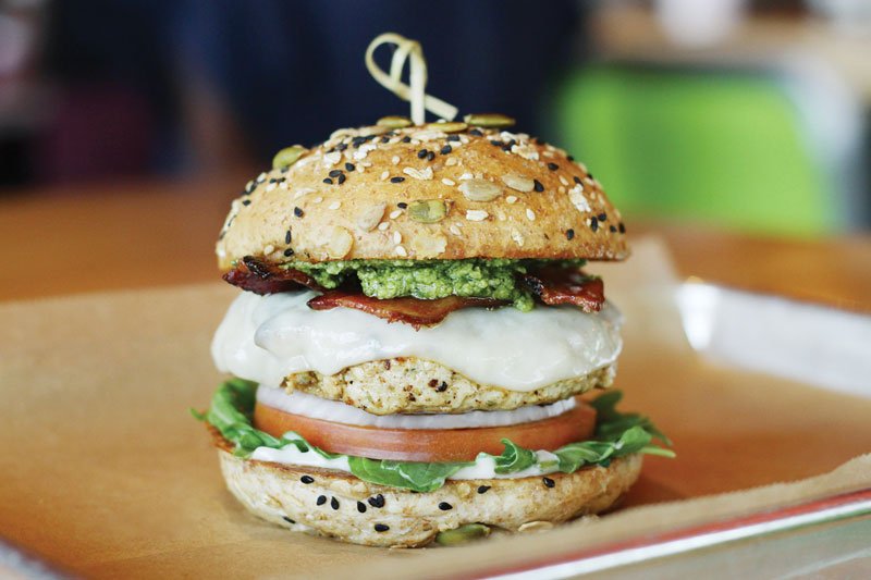 Lean and mean, the Continental Club Burger at Hopdoddy layers the turkey patty with flavor from provolone, bacon and basil pesto.