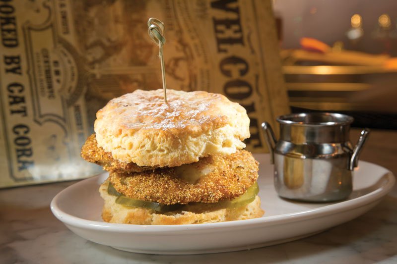 Cat Cora credits the craveability of her Fried Green Tomato Fat Biscuit Sammie, served at Fatbird in New York, to the combination of tart and juicy tomatoes with a crispy coating sandwiched between a warm, flaky biscuit