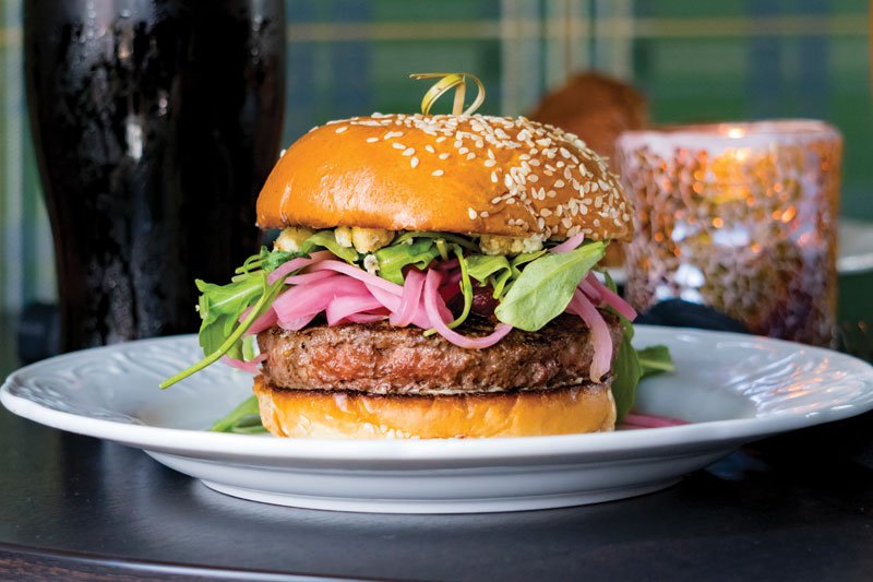 Tapping into a familiar flavor combination of bacon and blue cheese, the Stalking Horse Burger at The Stalking Horse in Los Angeles, serves up a thoroughly modern burger.