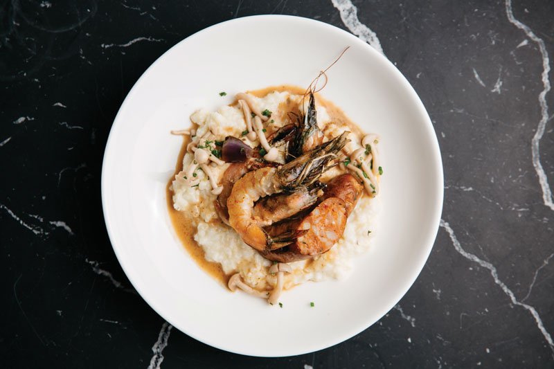 Bold and balanced, Geoffrey Zakarian’s Shrimp & Grits stars andouille sausage, cheddar, scallion and pickled mushrooms.