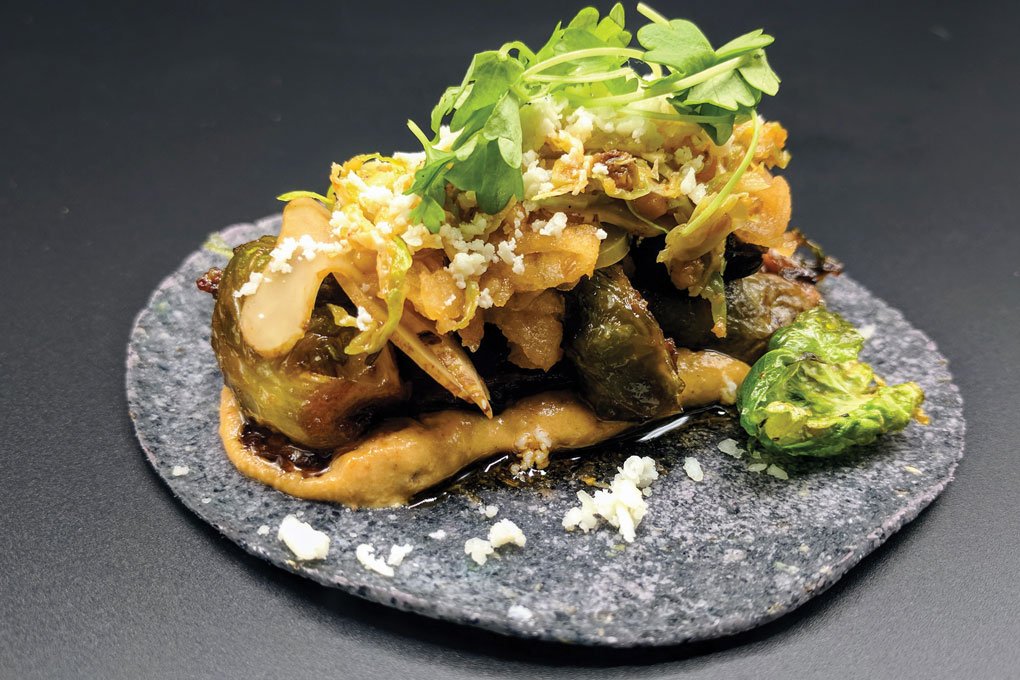 Espita Mezcaleria in Washington, D.C., serves “authentic, not traditional” tacos like this one, with roasted shaved Brussels sprouts, nut-and-seed slaw, salt-baked sunchoke, smoked almond, hazelnut and sesame crema.