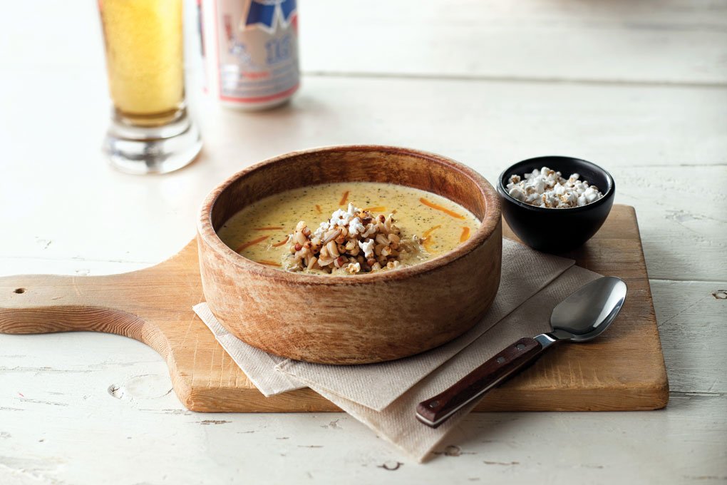 Oats, wild rice and both red and white sorghum combine with beer, broccoli and cheddar in this hearty, gluten-free soup. A garnish of popped sorghum and mixed grains adds fun textural play.