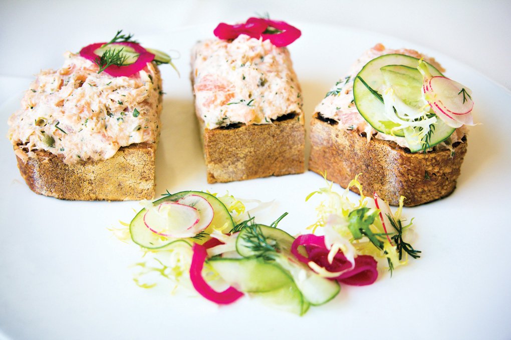 An inviting take on seacuterie at Nine-Ten Restaurant in La Jolla, Calif., easy-to-eat Salmon Rillettes Toast includes fresh and smoked salmon, preserved lemon, fresh herbs, capers, tossed greens and lemon vinaigrette.