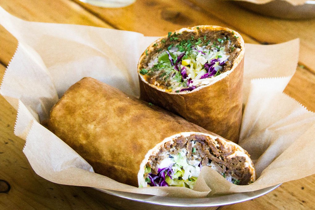 The Street Cart Döner features lavash wrapped around seasoned beef and lamb, or chicken, balanced with cool tzatziki and housemade aïoli and vegetables.