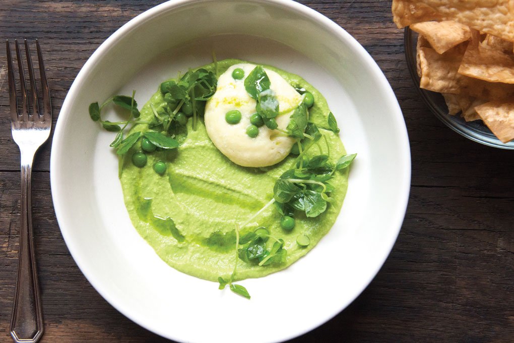 Vibrant, dippable purées like this Sweet Pea Hummus at Sur Lie in Portland, Maine, offer a purity of flavor. Mint oil and lemon sabayon add brightness.