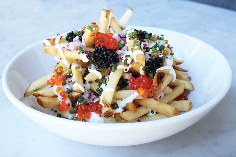 Petrossian in West Hollywood, Calif., turns to the perfect french fry as a carrier for two kinds of caviar, a drizzle of crème fraîche and a finish of chives.