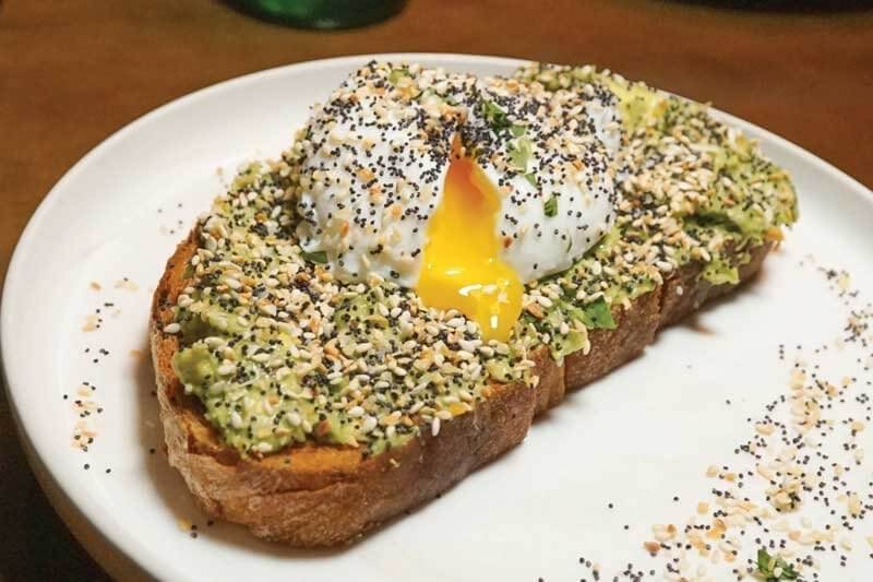 The upgraded avocado toast at Ella Elli in Chicago showcases a slow-poached egg sprinkled with “everything” seasoning.
