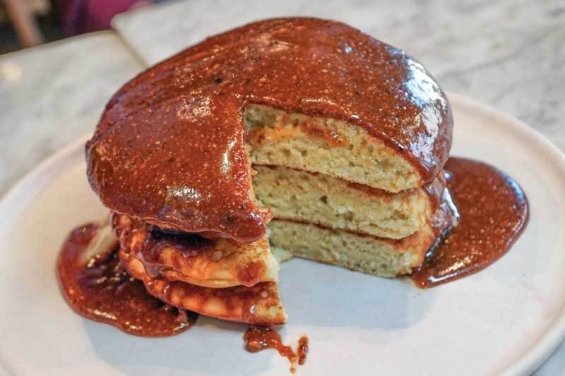 In Brooklyn, N.Y., big, shareable Malted Pancakes are topped with hazelnut-maple-praline sauce at Sunday in Brooklyn.