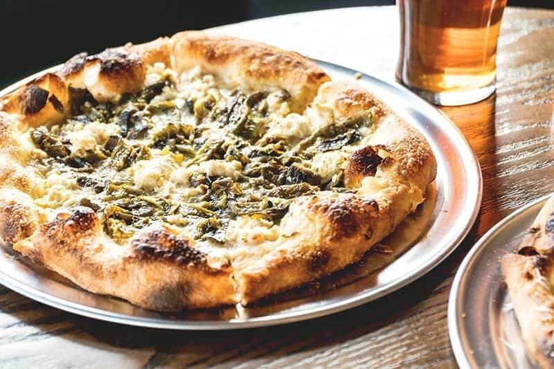 Charred Poblano Pizza at Brennan's in Marina Del Rey, Calif., balances the heat of the peppers with fresh cream, mozzarella, garlic confit and pecorino cheese.