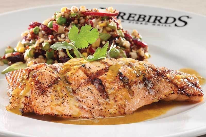 The Lemon-Basil Salmon at Firebirds Wood Fired Grill buddies up to a flavor-forward and distinctive cool salad of organic red quinoa, pearl barley, spring peas, radish, toasted pecans, grilled corn and goat cheese.