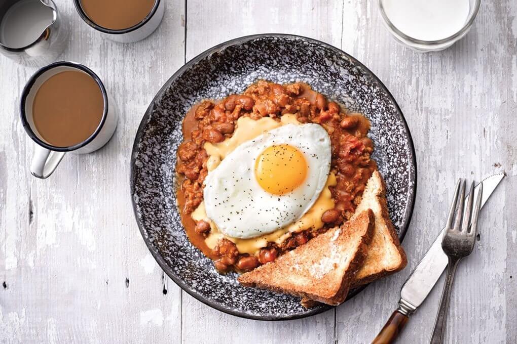 Hearty Breakfast Chili is crowned with queso and a fried egg