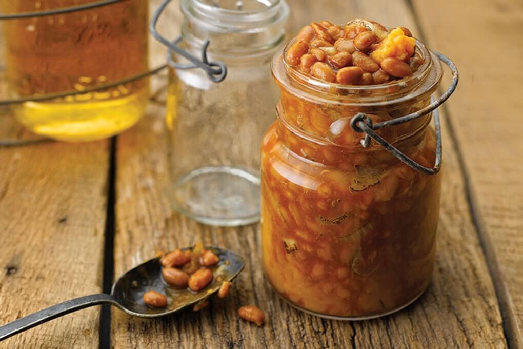This Moonshine-Laced Baked Beans with Sweet Potatoes stand out with a signature, boozy profile (see recipe below)