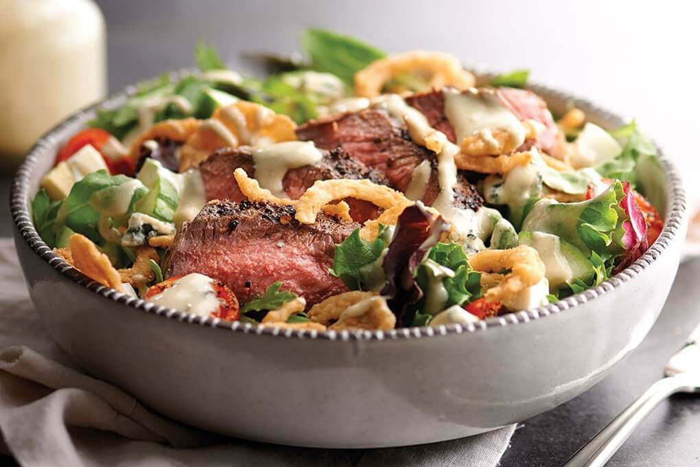 This Gorgonzola Steak Salad gets an unexpected but welcome garnish of crispy fried onions
