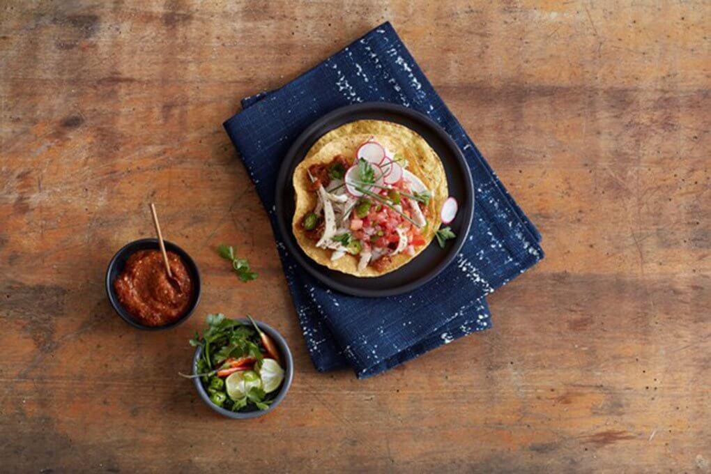 This Mole Amarillo Tostada boasts Oaxaca’s famous mole, along with pulled chicken, crema and pico de gallo, all on a corn tostada