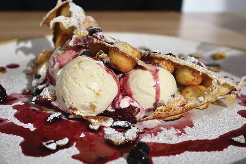 Hong Kong waffles have gone from simple street snack to elaborate brunch dish. Area Four in Cambridge, Mass., combines the waffles with pistachio ice cream and blackberry sauce. 