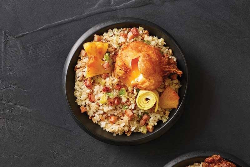 This Asian Breakfast Bowl demonstrates the opportunity. Boasting big flavor pops like roasted pineapple in a golden soy glaze, a pinwheel egg crêpe flavored with mirin and soy, and a soft-fried tempura egg—all over a blend of crispy sushi rice, cooked quinoa, farro and wheat berries.