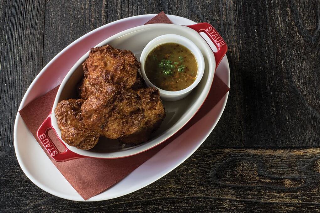 Chicago’s Split Rail serves updated, crispy fried chicken nuggets, nicely complemented by a vegetable-infused honey-mustard dipping sauce.